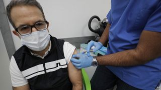 Doctor Khizer Hanif gives the AstraZeneca vaccine to a patient at a Pharmacy in Edgware, London, Tuesday, March 16, 2021.