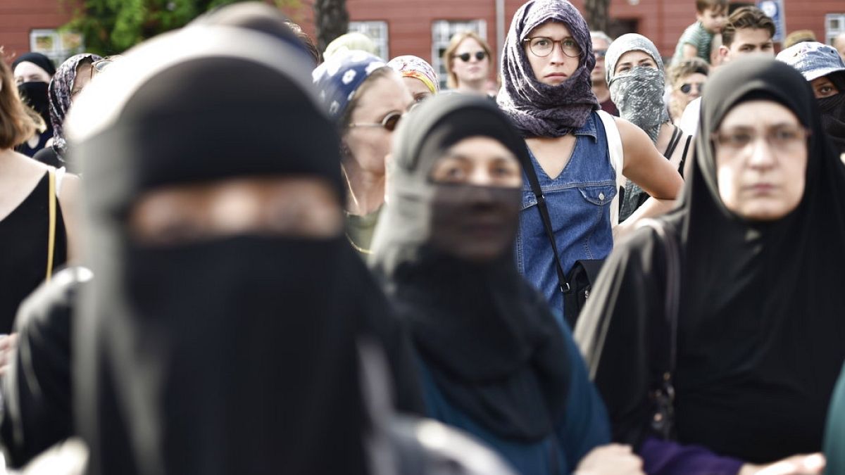 People oppose a burqa ban in Denmark. A similar ban exists in Austria, under which an animal rights activist was fined for wearing a cow mask. 