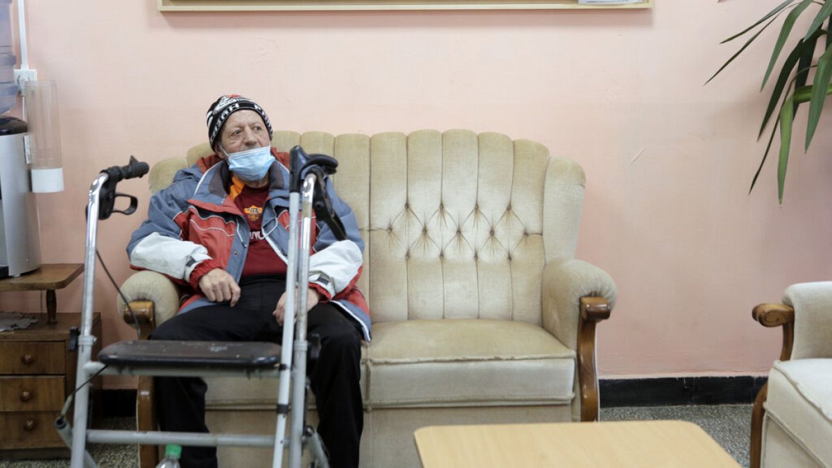 An elderly man waits to receive a dose of the COVID-19 vaccine, at Nadezhda nursing home, in Sofia, Wednesday, Jan. 27, 2021