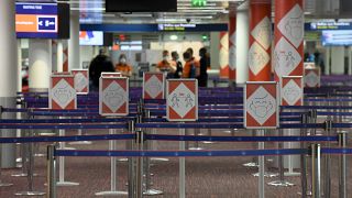 Placards with pictograms depicting Covid-19 sanitary instructions are pictured in Terminal 2E at the Roissy-Charles de Gaulle airport near Paris, March 18, 2021.