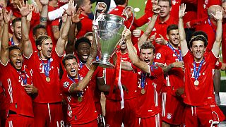 Munich players lift the trophy after Munich won the Champions League final soccer match between Paris Saint-Germain and Bayern Munich at the Luz stadium in Lisbon,