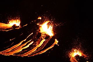 In this still image captured from a video filmed by the Icelandic Coast Guard, lava flows from the erupting Fagradalsfjall volcano, March 19, 2021.