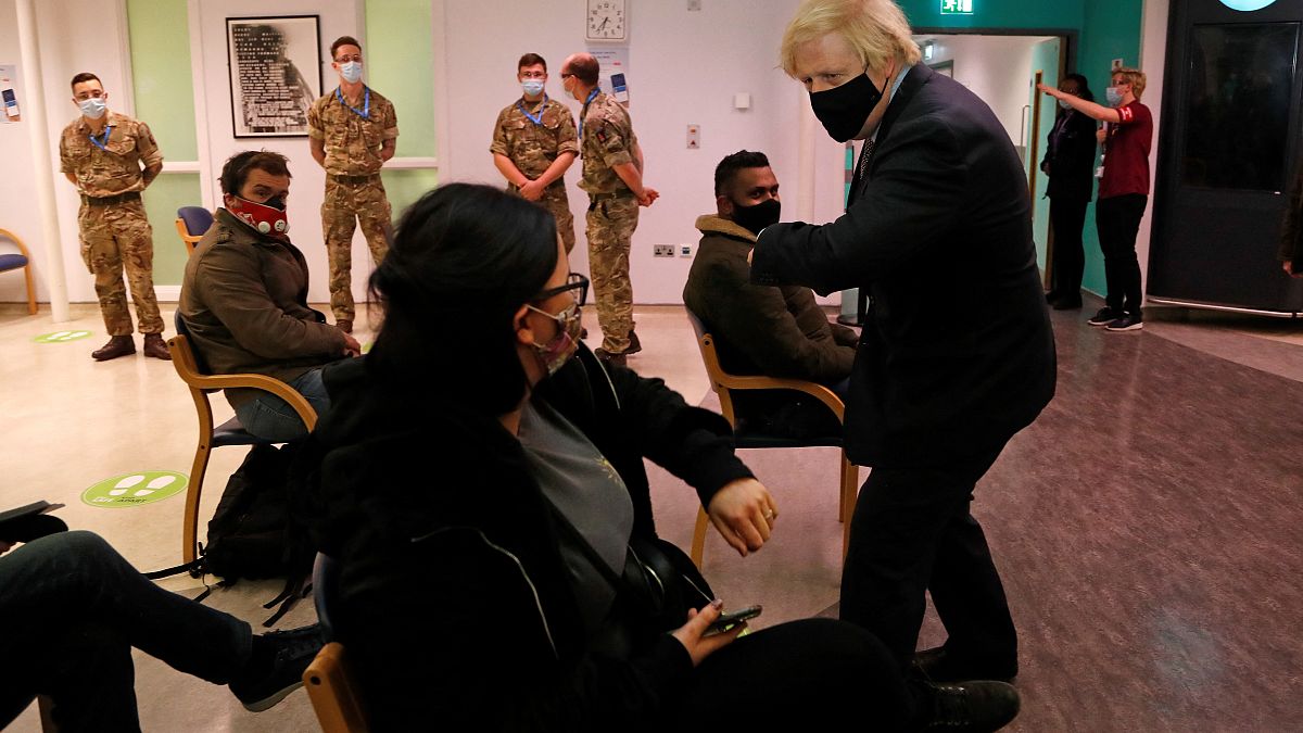 Britain's Prime Minister Boris Johnson speaks to members of the public who had just been vaccinated, at St Thomas' Hospital in London on March 19, 2021. 