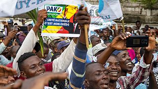 Supporters of opposition presidential candidate Guy Brice Parfait Kolelas cheer during their party's last rally of the presidential campaign in Brazzaville, Congo.