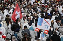 Protesters take part in a demonstration against the ongoing coronavirus Covid-19 restrictions in Liestal, near Basel, Switzerland, on March 20, 2021. 