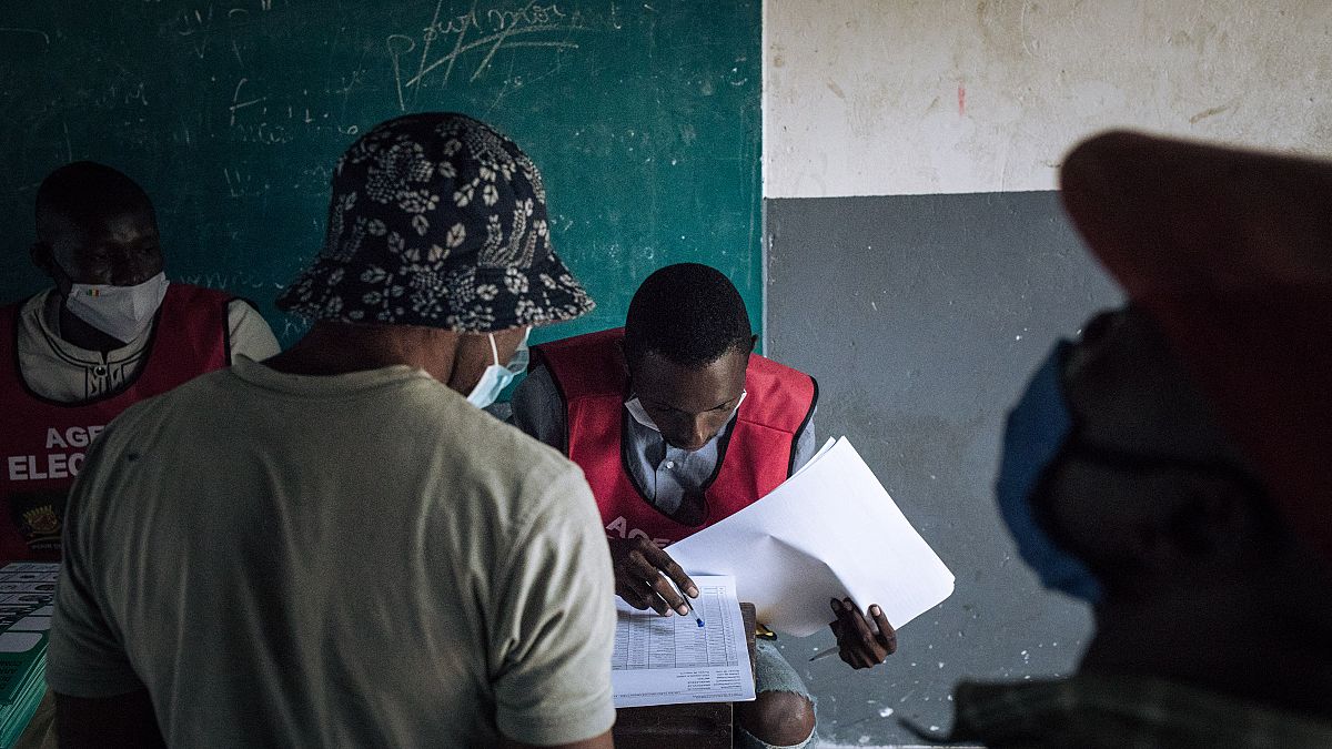 An electoral commission official checks the voters roll at a polling station in Brazzaville, Congo, on March 21, 2021. 