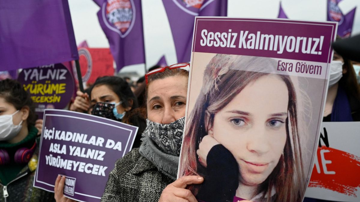 A protester holds a picture of a woman killed by a man at a demonstration against Turkey's withdrawal from the Istanbul Convention,  in Istanbul, on March 20, 2021. 