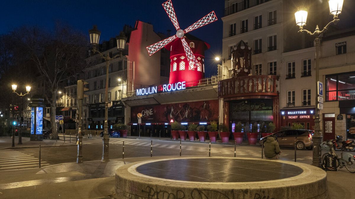Empty streets in front of the Moulin Rouge as the 7 p.m curfew starts in Paris, France, on Saturday, March 20, 2021. 