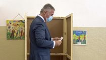 Montenegrin President Milo Djukanovic prepares his ballot to vote in parliamentary elections at a polling station in Podgorica, Montenegro, Sunday, Aug. 30, 2020.