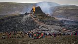  Hikers look at the lava flowing from the erupting Fagradalsfjall volcano, 40 km west of the Icelandic capital Reykjavik. March 21, 2021