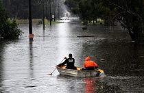 Residents commute via boat in a flooded residential area near Windsor, New South Wales. 