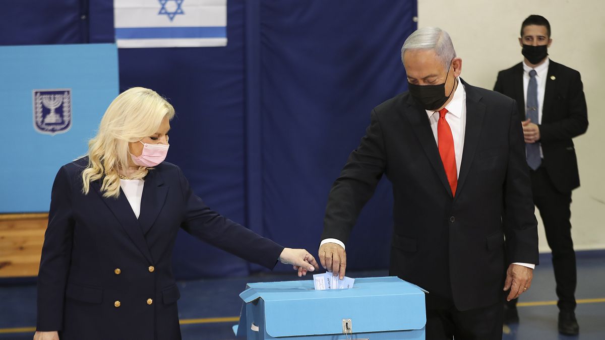 Israeli Prime Minister Benjamin Netanyahu and his wife Sara cast their ballots at a polling station as Israelis vote in a general election, in Jerusalem. March 23, 2021