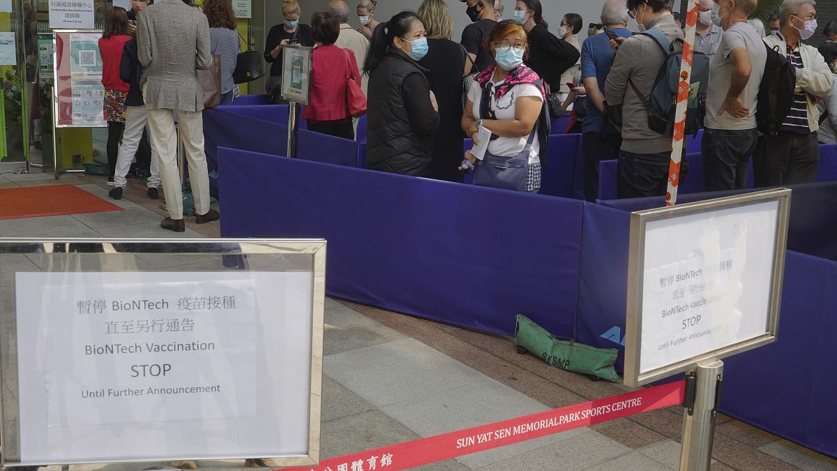 People queue up outside a vaccination center for BioNTech in Hong Kong Wednesday, March 24, 2021. 
