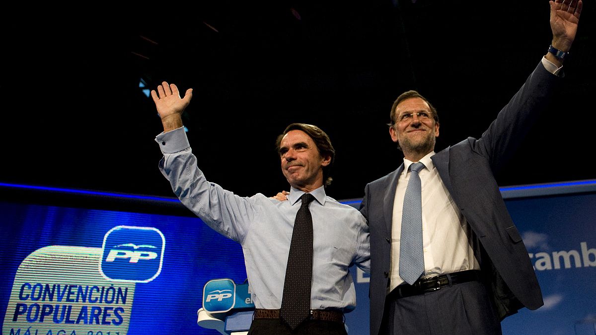 FILE:  Mariano Rajoy, then leader of the Spanish opposition party Partido Popular (PP), waves to supporters next to former PM Jose Maria Aznar, October 6, 2011