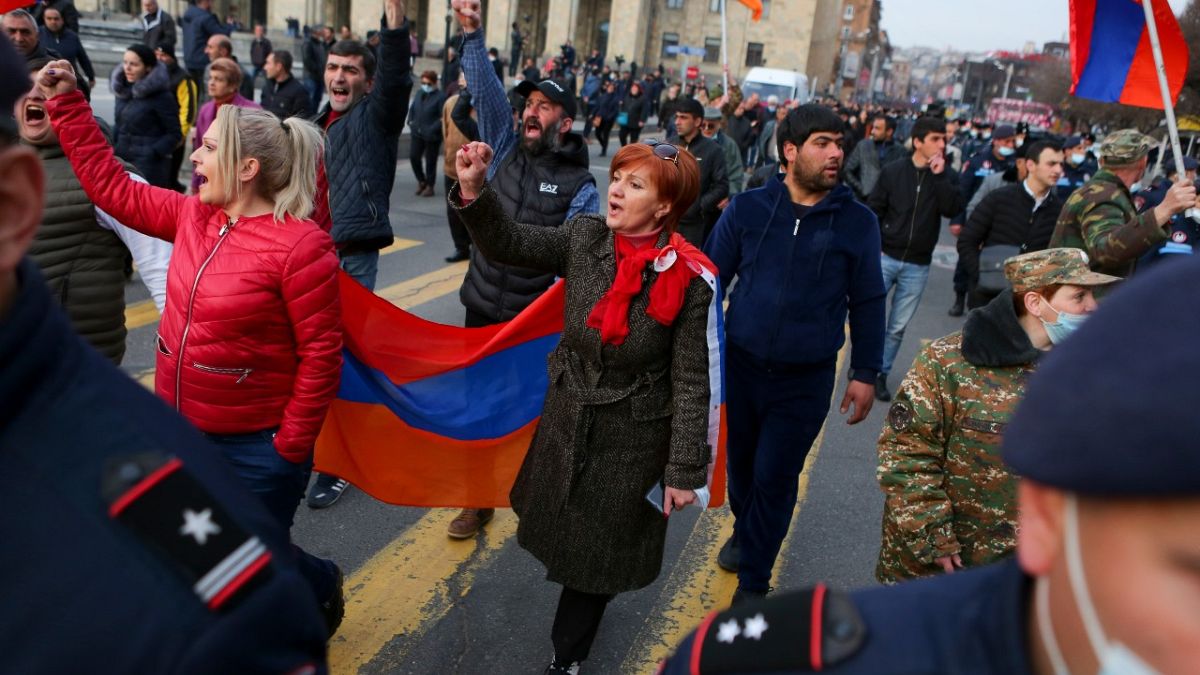 Opposition demonstrators with Armenian national flags rally to pressure Armenian Prime Minister Nikol Pashinyan to resign in Yerevan, Armenia, Wednesday, March 10, 2021.
