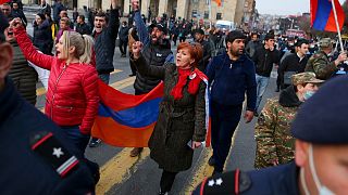 Opposition demonstrators with Armenian national flags rally to pressure Armenian Prime Minister Nikol Pashinyan to resign in Yerevan, Armenia, Wednesday, March 10, 2021.