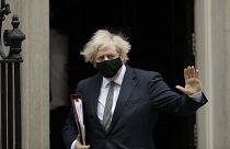 British Prime Minister Boris Johnson waves at the media as he leaves 10 Downing Street for the Houses of Parliament, in London, Wednesday, March 24, 2021.
