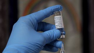 A syringe of the AstraZeneca vaccine is prepared in Ealing, London.