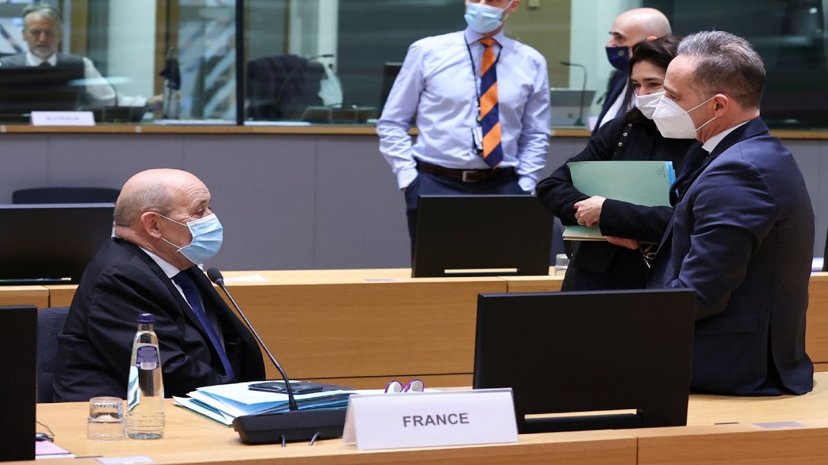 وزير الخارجية الفرنسي جون إيف لودريان يتحدث إلى وزير الخارجية الألماني هايكو ماس خلال اجتماع وزراء الخارجية الأوروبيين في مقر المجلس الأوروبي في بروكسل ، الاثنين 22 مارس 2021