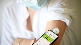 A woman with diabetes uses a glucometer to measure the glycemia in her blood. File picture. 