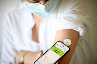 A woman with diabetes uses a glucometer to measure the glycemia in her blood. File picture. 
