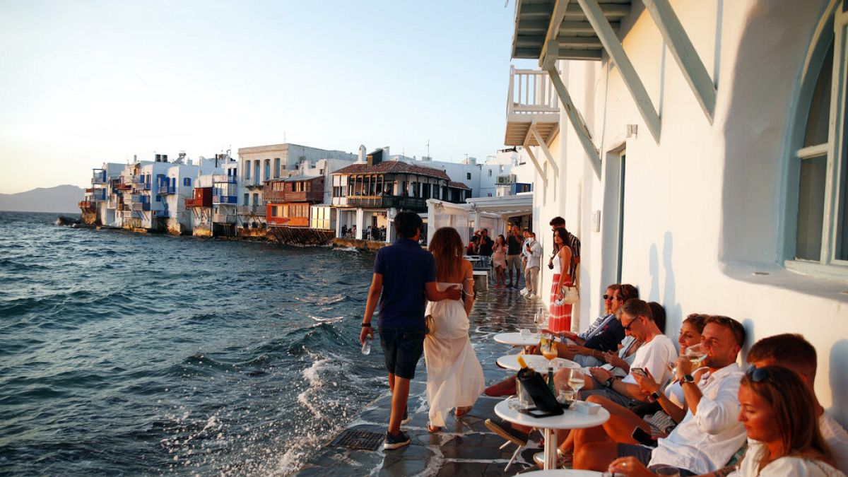 People sit at a bar in Little Venice on the Aegean Sea island of Mykonos