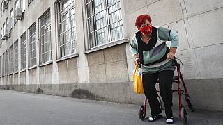 Budapesti egészségügyi intézmény előtt várakozó nő