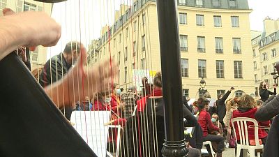 Paris musicians put on concert in front of occupied Odéon Theatre