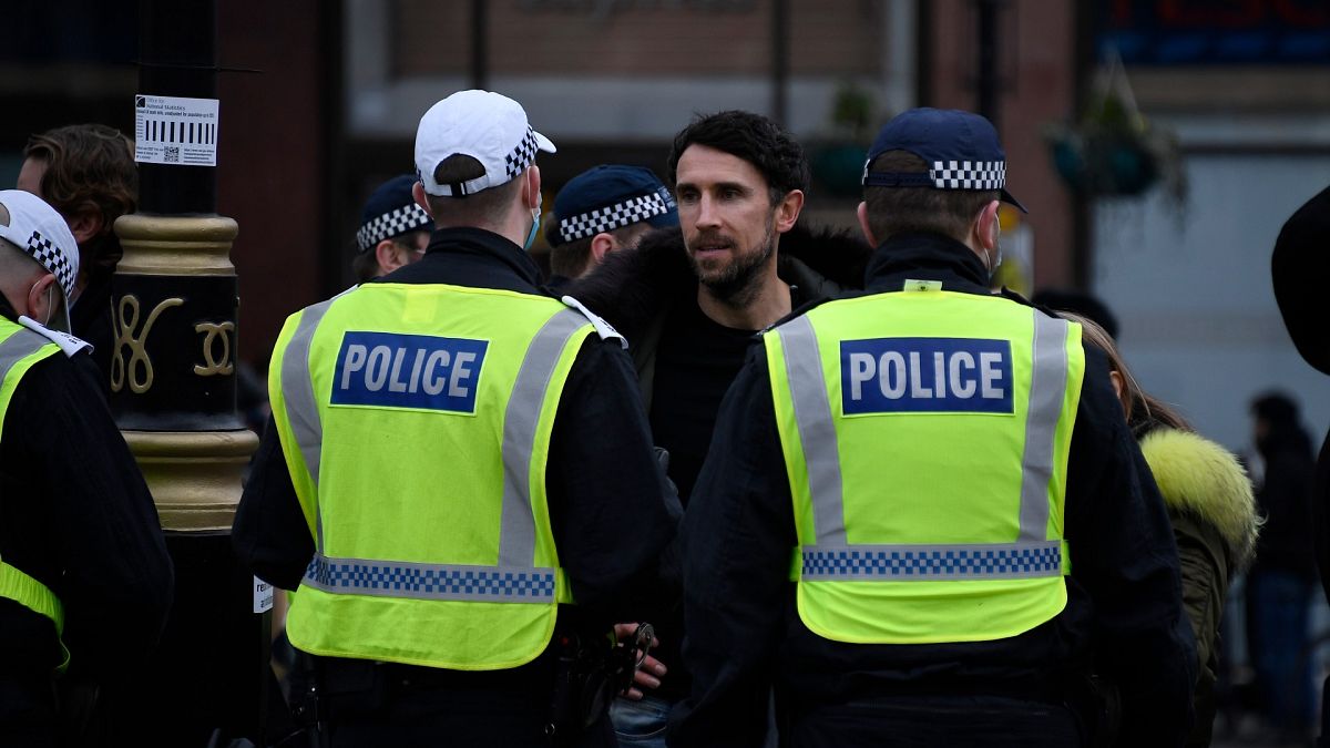 Police speak with demonstrators during a protest against government restrictions to curb the spread of the coronavirus, in London, March 20, 2021.