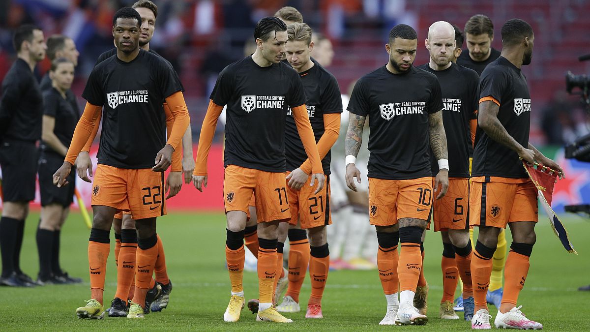 Netherlands' players enters on the field with shirts reading 'Football Supports Change' prior to the start of the World Cup 2022 qualifier vs Latvia on March 27, 2021.