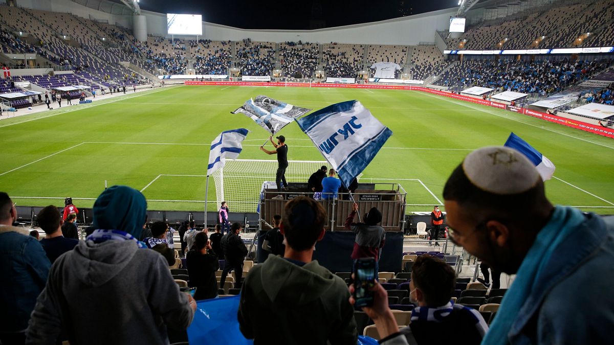 Israeli fans cheer before the World Cup 2022 group F qualifying soccer match between Israel and Denmark in Tel Aviv