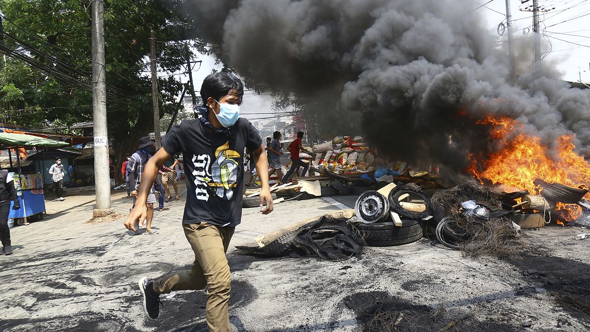 Myanmar'ın Yangon kentinde güvenlik güçlerinin ateşinden kaçmaya çalışan eylemci