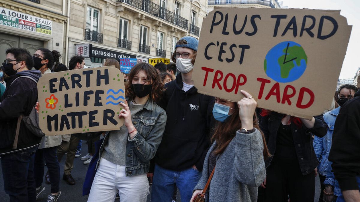 Youths hold placards during a rally against the climate change in Paris, March 28, 2021. Thousands of people took to the streets across France asking for tougher climate laws 