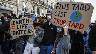 Youths hold placards during a rally against the climate change in Paris, March 28, 2021. Thousands of people took to the streets across France asking for tougher climate laws