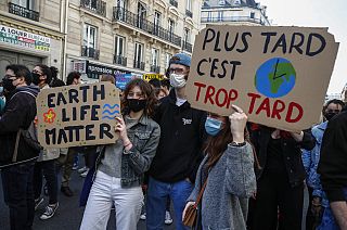 Youths hold placards during a rally against the climate change in Paris, March 28, 2021. Thousands of people took to the streets across France asking for tougher climate laws 