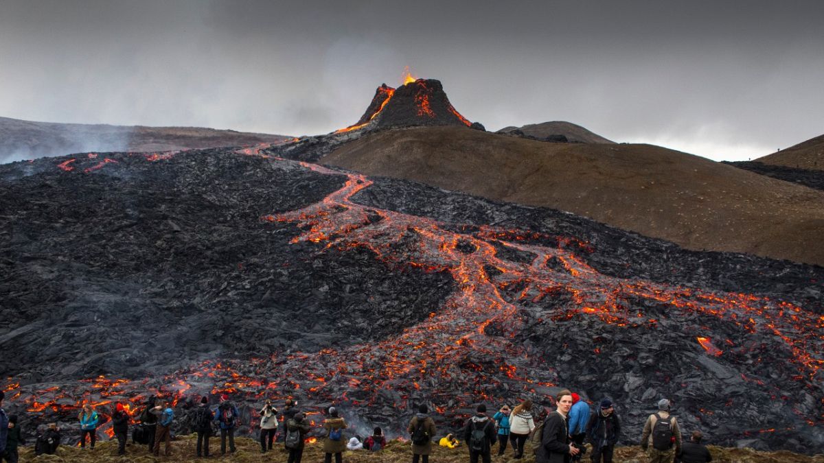 Lávaömlést figyelő turisták Izlandon