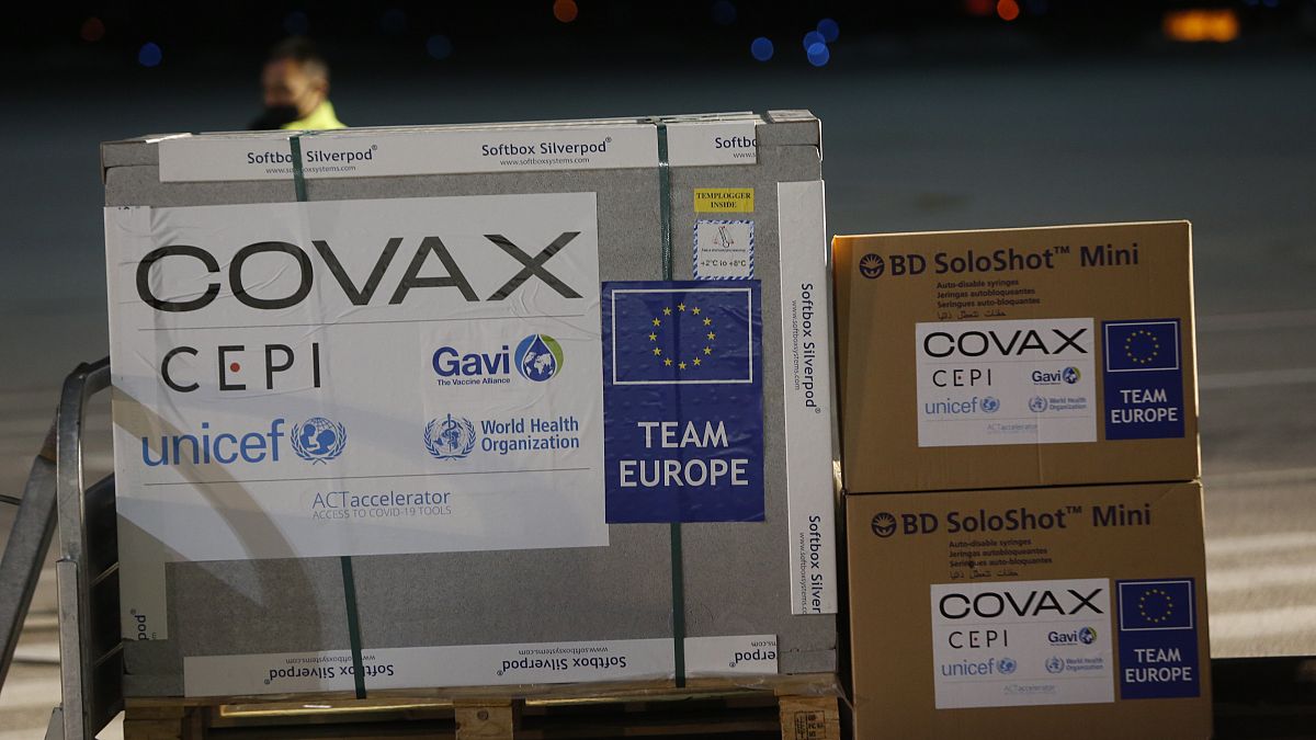Airport personal unload the first batch of AstraZeneca vaccines sent from the Covax facility.