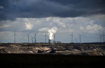 Wind turbines are seen near the open-cast mining and the coal-fired power station Neurath of German energy giant RWE in Garzweiler, western Germany.