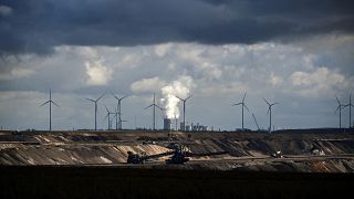 Wind turbines are seen near the open-cast mining and the coal-fired power station Neurath of German energy giant RWE in Garzweiler, western Germany.