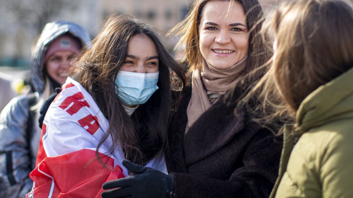 In this Saturday, March 20, 2021 file photo, Belarus opposition leader Sviatlana Tsikhanouskaya, right, poses for photos with protesters. 