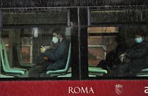 People wearing face masks to curb the spread of COVID-19, sit at distance in a tram in downtown Rome, Monday, March 15, 2021.
