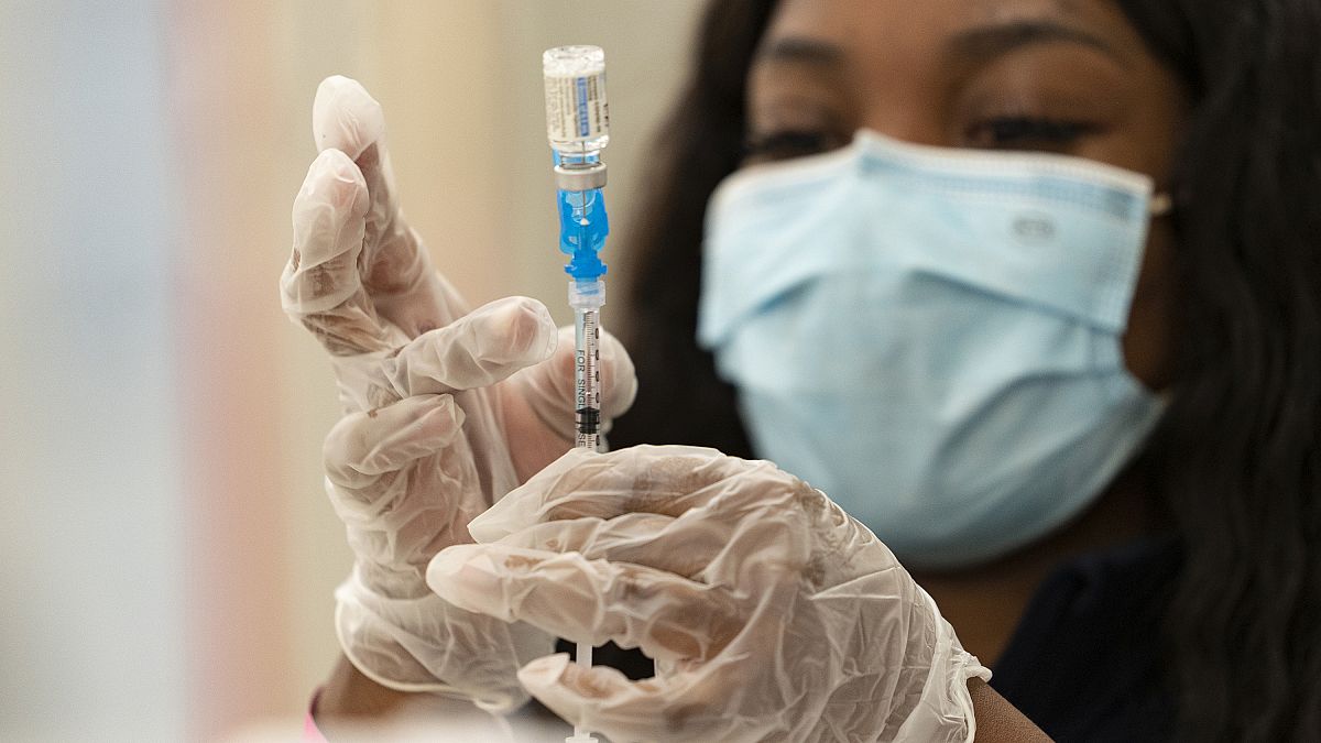 a health worker loads syringes with the vaccine on the first day of the Johnson & Johnson vaccine being made available to residents in Los Angeles, California.