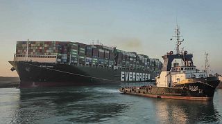 In this photo released by Suez Canal Authority, the Ever Given, a Panama-flagged cargo ship, is pulled by one of the Suez Canal tugboats, in the Suez Canal, Egypt