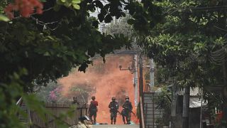 Soldiers walk towards anti-coup protesters during a demonstration in Yangon, Myanmar on Tuesday March 30, 2021. 