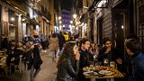 Tourists and locals have drinks at a bar in downtown Madrid, Spain, Friday, March 26, 2021.