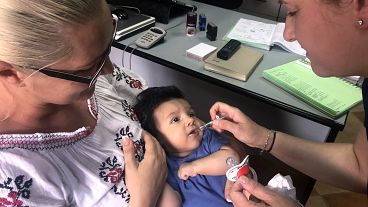 Foto de 6 de junho de 2018, uma criança recebe uma dose de vacina em Chitila, Roménia. Um surto de sarampo matou dezenas de bebés e crianças na Roménia, com 200 novos casos registados