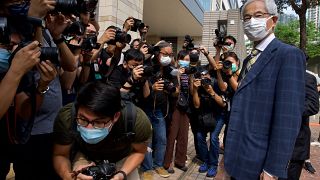 Pro-democracy lawmaker Martin Lee, right, arrives at a court in Hong Kong Thursday, April 1, 2021.