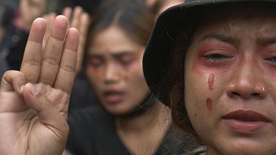 Crying and song as Myanmar anti-coup protesters don red 'blood' tears