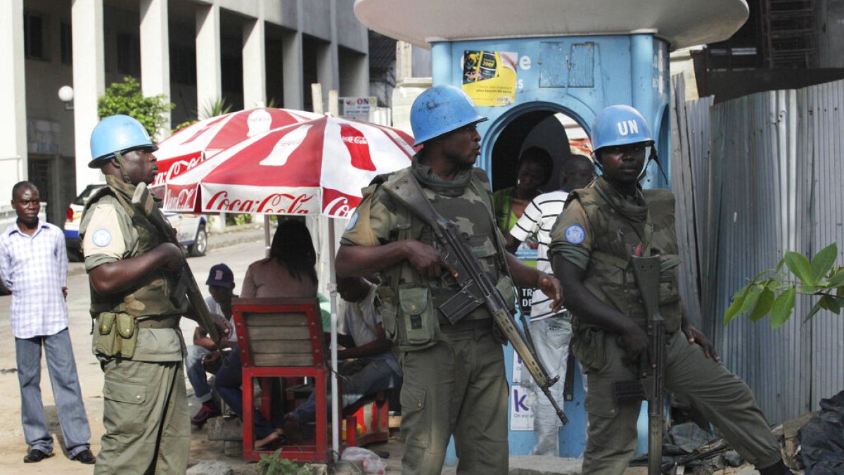 FILE: UN forces stand guard on a street in Abidjan, Ivory Coast, Dec. 22, 2010.