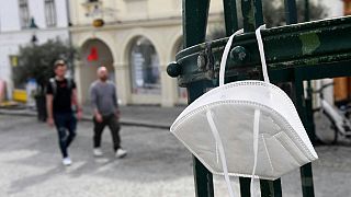 A discarded FFP2 face mask hangs on a grid in Eisenstadt, Austria